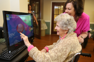 Older Woman with Assitant on a Computer