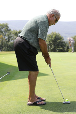 Golfer taking a putt